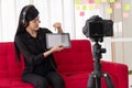 Vlog Asian woman blogger influencer sitting on the sofa in home and recording video blog for teaching and coach her Students or Royalty Free Stock Photo