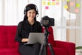 Vlog Asian woman blogger influencer sitting on the sofa in home and recording video blog for teaching and coach her Students or Royalty Free Stock Photo