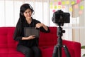 Vlog Asian woman blogger influencer sitting on the sofa in home and recording video blog for teaching and coach her Students or Royalty Free Stock Photo