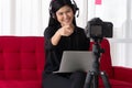 Vlog Asian woman blogger influencer sitting on the sofa in home and recording video blog for teaching and coach her Students or Royalty Free Stock Photo