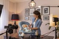 Vlogger making video about use of newborn baby swing seat Royalty Free Stock Photo