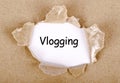 Vlogging word written on torn paper