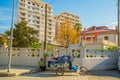 VLORA-VLORE, ALBANIA: A street vendor on a bicycle sells socks outside the Independence Museum.