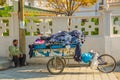 VLORA-VLORE, ALBANIA: A street vendor on a bicycle sells socks outside the Independence Museum.