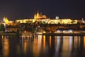 Vltava river, Charles Bridge with illumination and Prague Castle with amazing Saint Vitus Cathedral Royalty Free Stock Photo