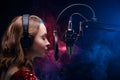 Vocal teacher singing with a studio microphone in a studio with a bright background. Teaching vocals and solo singing. Soundtrack