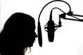 Vocals with studio microphone, silhouette. Black and white photo Royalty Free Stock Photo