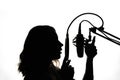 Vocals with studio microphone, silhouette. Black and white photo Royalty Free Stock Photo