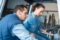 vocational instructor teaching female apprentice how to drive Royalty Free Stock Photo