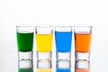 Vodka color shots filled with alcohol on glass bar table Royalty Free Stock Photo