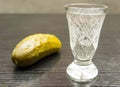 Vodka in a crystal glass and pickled cucumber. Royalty Free Stock Photo