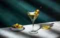 Vodka martini, classic alcoholic cocktail drink with vodka and vermouth, green olives garnish, dark background, bright hard light Royalty Free Stock Photo