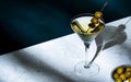 Vodka martini with olives, alcoholic cocktail drink with vodka and vermout, dark green background, bright hard light and shadow Royalty Free Stock Photo
