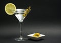 Vodka martini white transparent alcoholic cocktail drink in the glass on the black background. Royalty Free Stock Photo