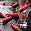 Vodka shot with chili peppers on rusty grunge table Royalty Free Stock Photo