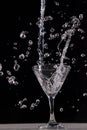 Vodka splashing in martini glass Royalty Free Stock Photo