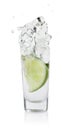 Vodka splashing out of shot glass with lime on white background Royalty Free Stock Photo