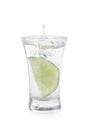 Vodka splashing out of shot glass with lime on white background Royalty Free Stock Photo