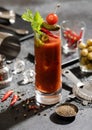 Vodka and tomato juice bloody mary cocktail with spoon,strainer and olives in bar with ground black pepper Royalty Free Stock Photo