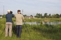 Vogelaars bij waterplas; Birdwatchers at lake Royalty Free Stock Photo