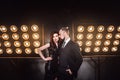 Vogue and sensual concept. Elegant celeb couple posing on the stage near lamp Royalty Free Stock Photo