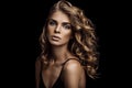 Vogue style close-up portrait of beautiful woman with long curly hair