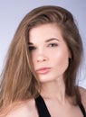 Vogue style portrait. Beautiful young woman with long hair and nude makeup