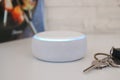Amazon echo dot , Alexa voice controlled speaker with activated voice recognition, on brick and white background