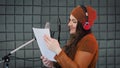 Voice over or dubbing recording in studio, reading text from script. Voice artist acting a role of some cartoon character