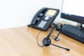 VOIP headset for callcenter on desk at customer service office. Communication support for sale support and telemaketing Helpdeskac