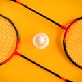 Volant and racket, badminton on yellow background. Concept excitement, resistance, competition. Pop Art Minimalism