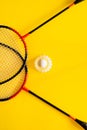 Volant and racket, badminton on yellow background. Concept of summer entertainment. Pop Art Minimalism