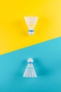 Volant and racket, badminton on yellow, blue background. Concept excitement, resistance, competition. Pop Art Royalty Free Stock Photo