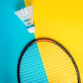 Volant and racket for playing badminton on yellow background. The concept of summer entertainment. Minimalism Pop Art