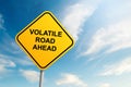 Volatile road ahead road sign with blue sky and cloud background Royalty Free Stock Photo