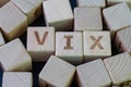 Volatility Index, known by its ticker symbol VIX concept, cube wooden block with alphabet combine the word VIX on black chalkboard