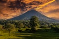 Volcan Arenal dominates the landscape during sunset,