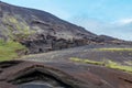 Volcanic black rock layers and layered cliffs