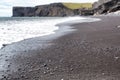 Volcanic black sand and volcanic rocks on the Iceland beach