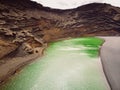 Volcanic crater with a green lake near El Golfo at Lanzarote island, Spain Royalty Free Stock Photo