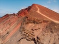 Volcanic crater with red slope near La Santa, Lanzarote. Aerial view
