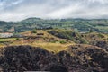 Volcanic and dark rocks, with hill and famous viewpoint of the Ship, fog in mountains, SÃ£o Miguel - Azores PORTUGAL Royalty Free Stock Photo