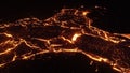 Volcanic eruption with glowing orange lava flow surrounded by a pool of bubbling magma