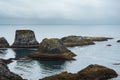 volcanic islets off the Icelandic coast, near the famous Gatklettur stone bridge