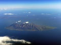 volcanic isolated island in the blue mediterranean sea clouds Royalty Free Stock Photo