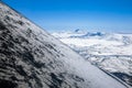 Volcanic landscape with diagonal slope and lake in the crater of another volcano Royalty Free Stock Photo