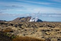 Volcanic landscape of Reykjanes peninsula with lava fields and gas steam of Svartsengi Geothermal Power Plant and Blue Lagoon,