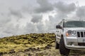Volcanic lava fields covered in moss, with 4x4 off-road jeep in