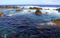 Volcanic lava-formed rocks in coastal surf waves at Biscoitos, northern coast of Terceira, Azores, Portugal