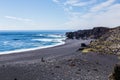 Volcanic pebble beach with black lava rocks Royalty Free Stock Photo